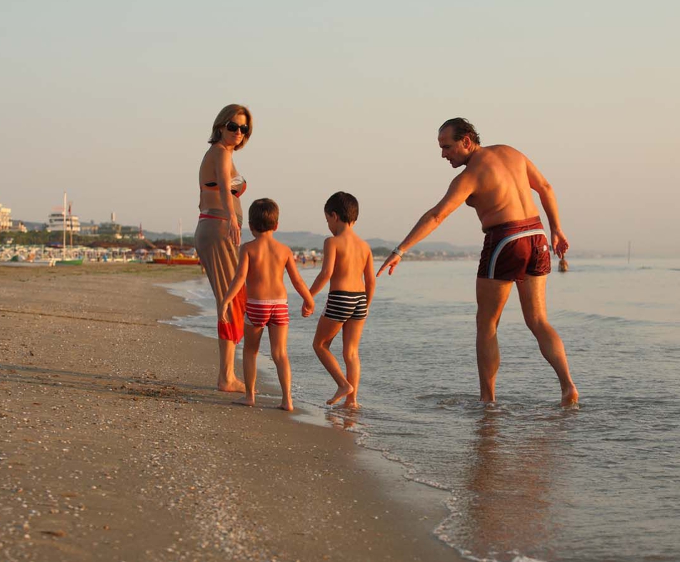 Shot of a happy young family running on the beach