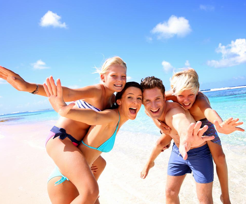 Shot of a happy young family running on the beach